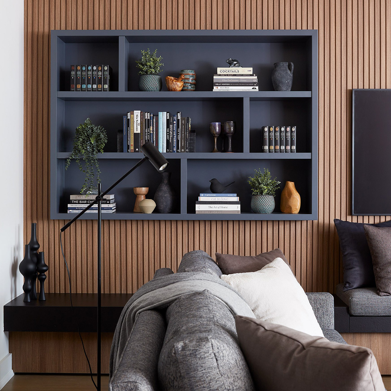 A before and after slider showcasing the change to a custom living room bookcase when it is professionally accessorized.